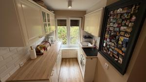 a kitchen with a hallway with a counter and a window at Pod Świerkami in Boszkowo