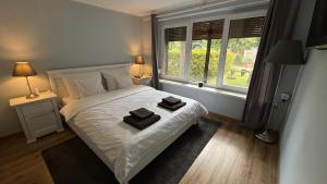 a bedroom with a bed with two towels on it at Pod Świerkami in Boszkowo