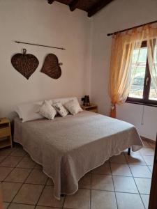 a bedroom with a bed with hearts on the wall at AffittaSardegna - Casa il Giardino dell'Erica in Porto Istana