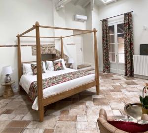 a bedroom with a canopy bed in a room at Villa Chloé Boutique Wine Relais in Montecalvo Versiggia +51 photos