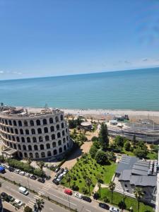 a view of a building and the beach at Batumi Seaside Apartments in Angisa