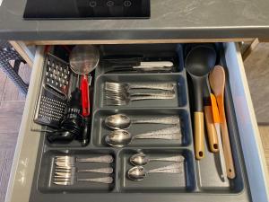 a tray with silver utensils in a drawer at Thealos Rooms in Vourvourou