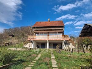 a building with a roof on top of a field at Panoramic house in Szigliget in Szigliget