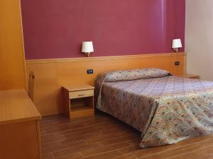 a bedroom with a bed and a nightstand with two lamps at Beauty Rooms in Rome +13 photos