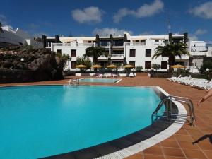 a large swimming pool in front of a hotel at B16 caleton blanco in Puerto del Carmen +9 photos