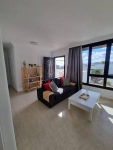 a living room with a couch and a table at B16 caleton blanco in Puerto del Carmen