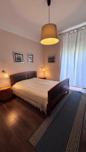 a bedroom with a large bed and a large window at Little Paradise - charming apartment in Labin