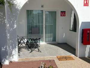 a patio with a table and chairs in front of a building at 42 Guacimeta Club in Los Pocillos