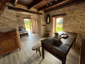 a room with a wooden desk in a stone building at La ferme des Soudanières in Ceyzériat