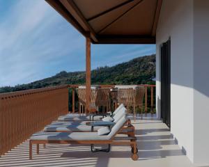 a row of lounge chairs on a balcony at Coral Strand Smart Choice in Beau Vallon