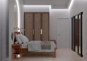 a bedroom with a bed with white pillows at Coral Strand Smart Choice in Beau Vallon