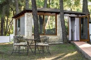 a table and two chairs in front of a cabin at Sani Villa Elmira in Sani Beach