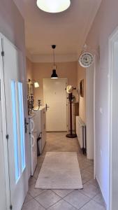 a room with a hallway with a door and a kitchen at Little Paradise - charming apartment in Labin +4 photos
