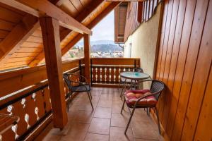 a balcony with chairs and a table and a view at Rooms&Apartments Pazlar in Bled