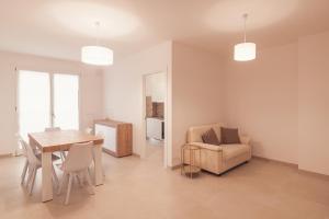 a living room with a table and a chair at Alessia in wonderland in Alghero