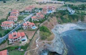 a group of houses on a hill next to the ocean at Appart complex - Egrek 3 in Lozenets