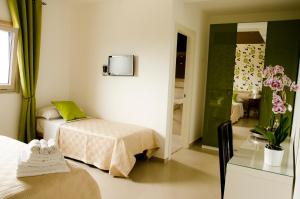 a hotel room with two beds and a mirror at Villa Le Favole in Sant'Egidio del Monte Albino +26 photos