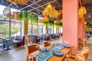 a dining room with tables and chairs and chandeliers at Greenwood Hotel Restaurant & Spa in Batumi +59 photos
