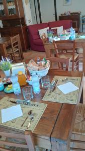 a wooden table with plates of food on it at ANTICHE TERRE Di GALLURA in Monti