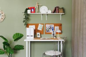 a desk in a room with a clock on a wall at Harmonic Nest 3min to Republic Square Renovated in Belgrade