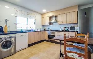 a kitchen with a washer and dryer in it at Amazing Home In Xàtiva in Xàtiva
