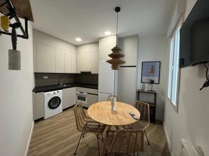 a kitchen with a table and chairs in a room at Habitaciones plaza payor in Madrid
