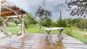 a bench sitting on top of a wooden deck at Jurta na Krupinskej planine in Krupina