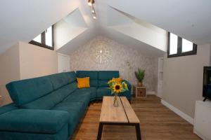 a living room with a blue couch and a table at Había Una Vez in El Espinar