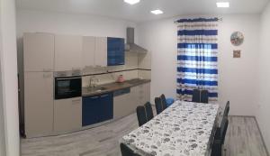 a kitchen with a table and a table and chairs at Apartment Zaglav in Zaglav