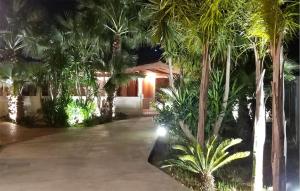 a house with palm trees in front of a driveway at Gorgeous Home In Vittoria in Vittoria +20 photos