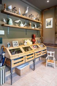 een kamer met een grote houten vitrine met planken bij La Moutinière, luxury cottage with pool in Manerbe
