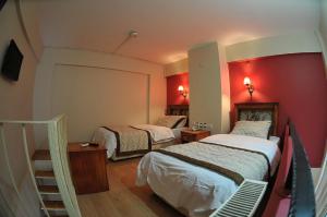 Ένα ή περισσότερα κρεβάτια σε δωμάτιο στο Antikhan Hotel