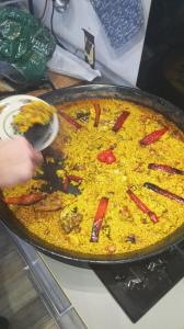 a pan of food with peppers on top of it at Casa bohemia cerca del mar in La Marina