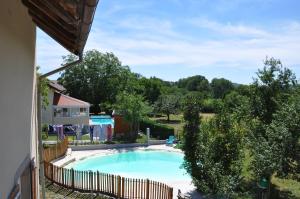 a swimming pool with a fence around it at Gite de la combe in Désandans