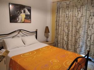 a bedroom with a bed with a yellow bedspread at Elani house in Elani