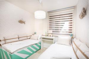 a room with two beds and a desk and a window at CC8 III by ZANIS in Torrevieja +16 photos