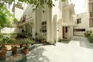 a courtyard with potted plants in a building at Art KOTHI Gurgaon in Gurgaon