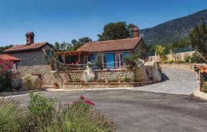 a house with a stone driveway in front of it at House Victoria 1 by Villas Guide in Nerezine