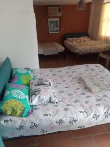 a bedroom with a bed with a blanket on it at Hostal ROLLED in Villavieja +6 photos