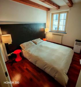 a bedroom with a large bed and a window at Home Art & Design in Trieste