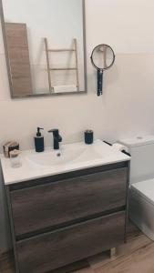 a bathroom with a white sink and a mirror at Nuestro Refugio Rural in Cortijos Nuevos +25 photos