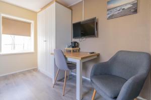 TV a/nebo společenská místnost v ubytování B&B Plompetorenzicht