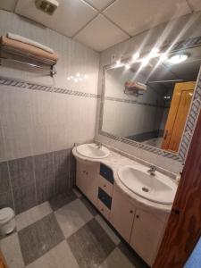 a bathroom with a sink and a mirror at House in Orihuela. Sea view. in Orihuela