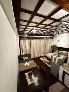 a small room with a bed and a table in it at Bayay ni Mamang Siargao - Ground Level in General Luna