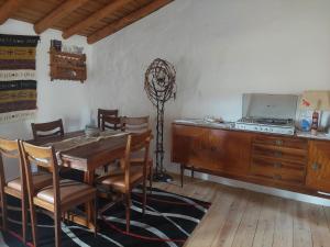 a dining room with a table and chairs and a television at Casa da Tartaruga - Marvão in Santo António das Areias