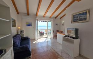een woonkamer met een bank en een tv bij Vila Medea sea view by Villas Guide in Medveja