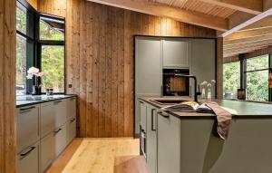 a kitchen with wooden walls and wooden flooring at Beautiful Home In Børkop With Sauna in Børkop