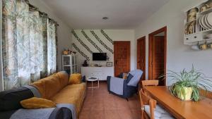 a living room with a couch and a table at Las Casucas del Cartero in Cantabria