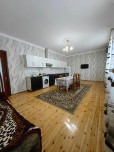 a kitchen and dining room with a table and chairs at Marvel in Mekhrably +9 photos