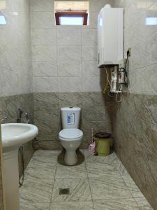 a bathroom with a toilet and a sink at Marvel in Mekhrably